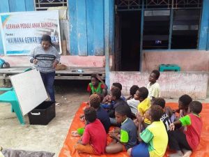 Seorang Relawan Literasi saat Memberikan Pelajaran Kepada Anak-Anak Kompleks Kokonau